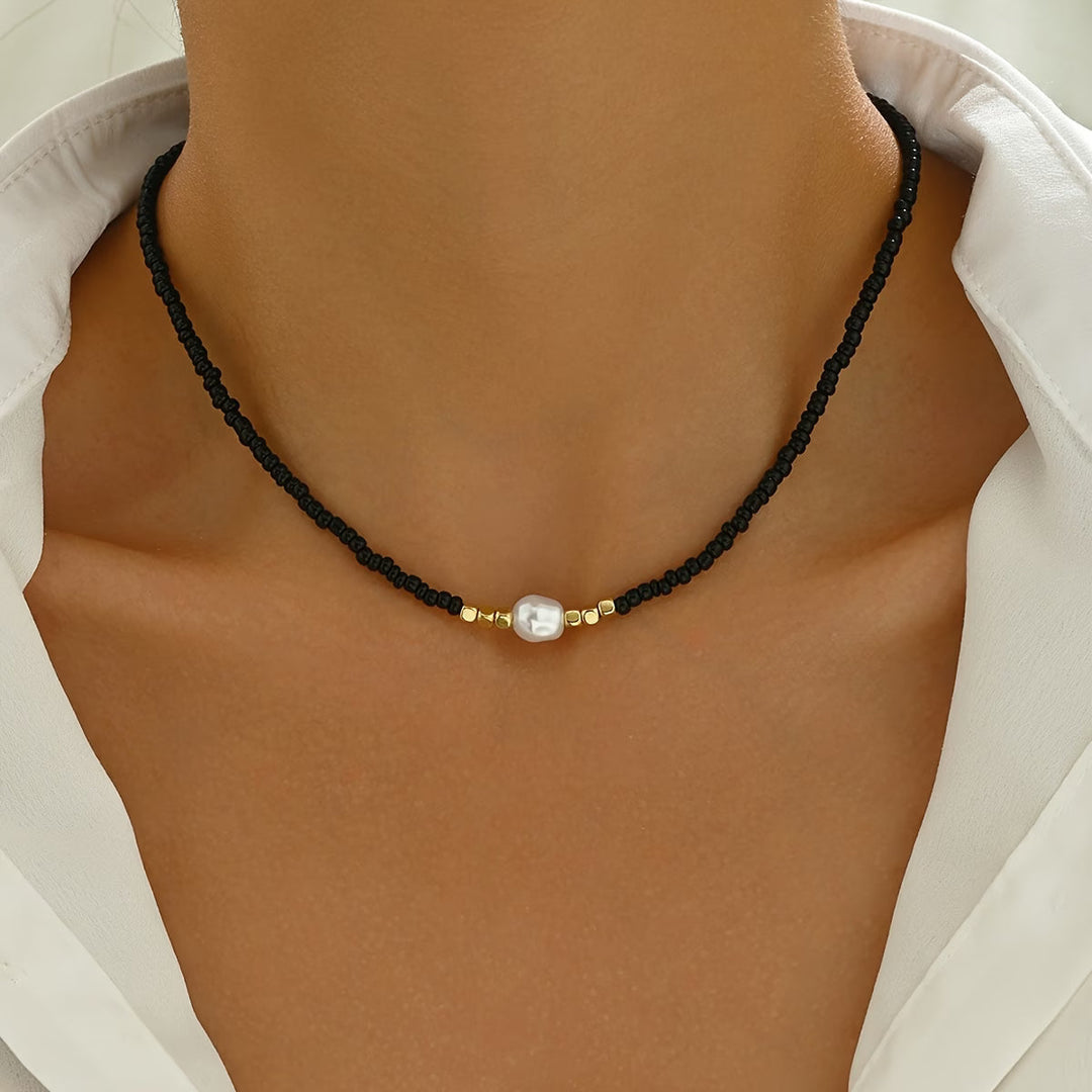 Pearl necklace shown coiled to display the fine chain