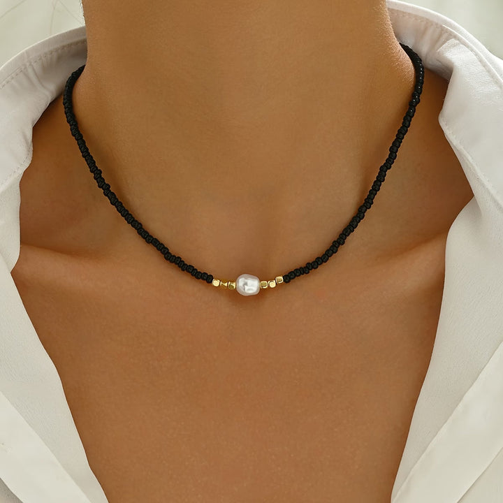 Pearl necklace shown coiled to display the fine chain