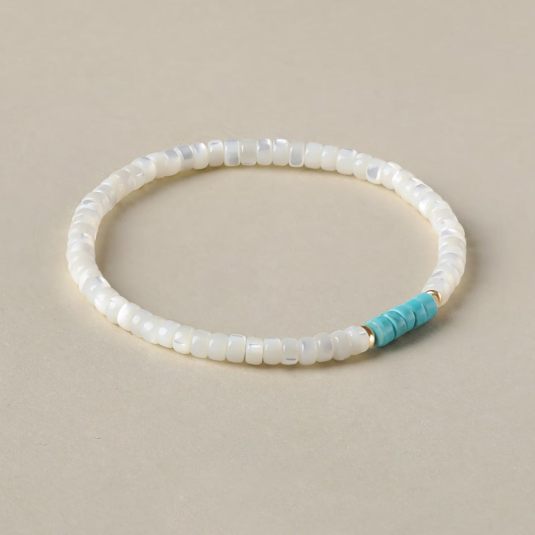 Close-up of alternating pearl and turquoise beads