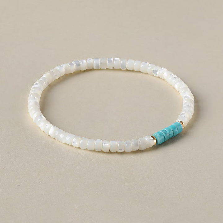 Close-up of alternating pearl and turquoise beads