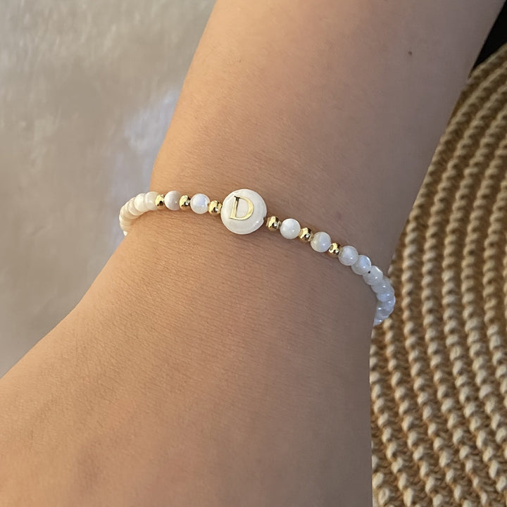 Close-up of the pearl and charm catching the light
