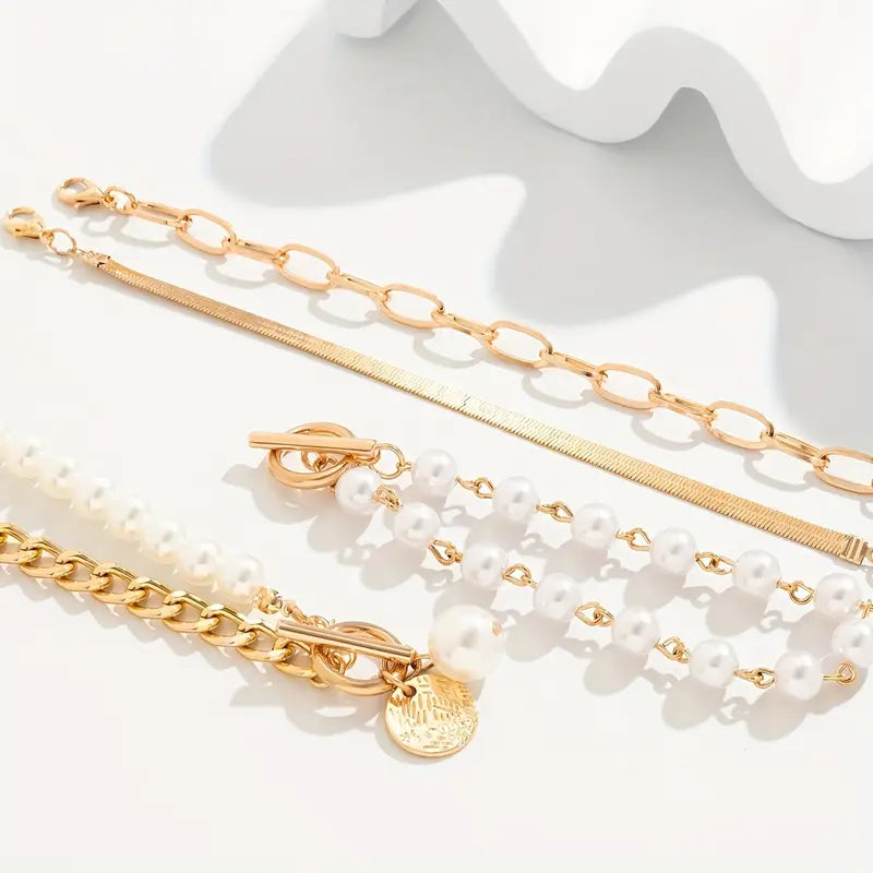 Close-up of pearls layered against fine gold-tone chain links