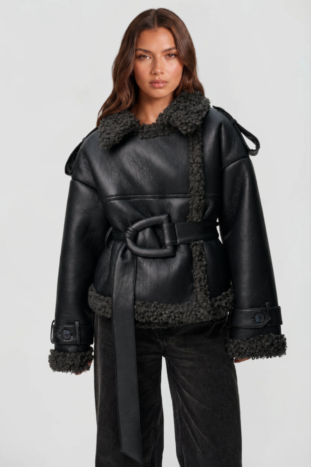 Black faux leather shearling jacket with oversized buckle belt, close front view