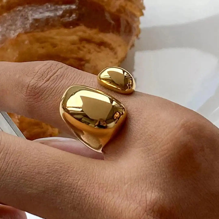 Main shot of the minimalist gold flow ring