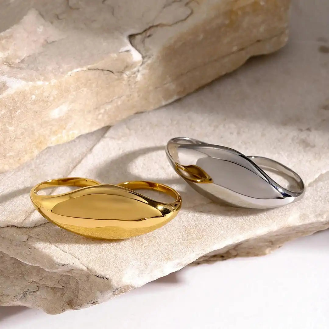 Ring worn across two fingers on a model's hand