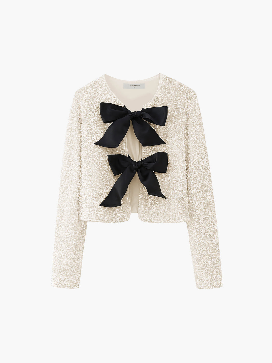 Ivory sequin cropped jacket with two black bow ties, flat front product shot