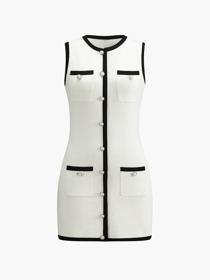 Front view of the white colourway with black contrast trim, pearl buttons and patch pockets