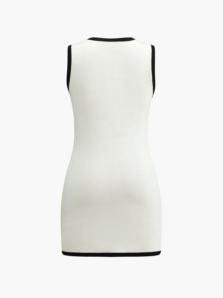 Back view of the white sleeveless knit mini dress with black binding at neckline and hem
