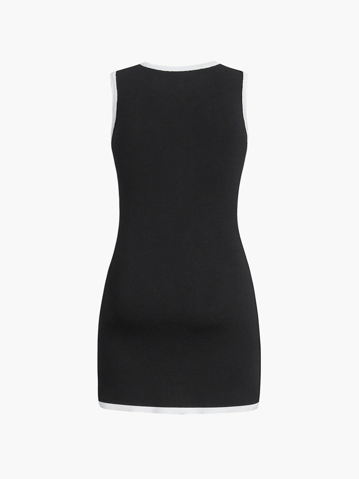 Back view of the black sleeveless knit mini dress with white trimmed neckline and hem