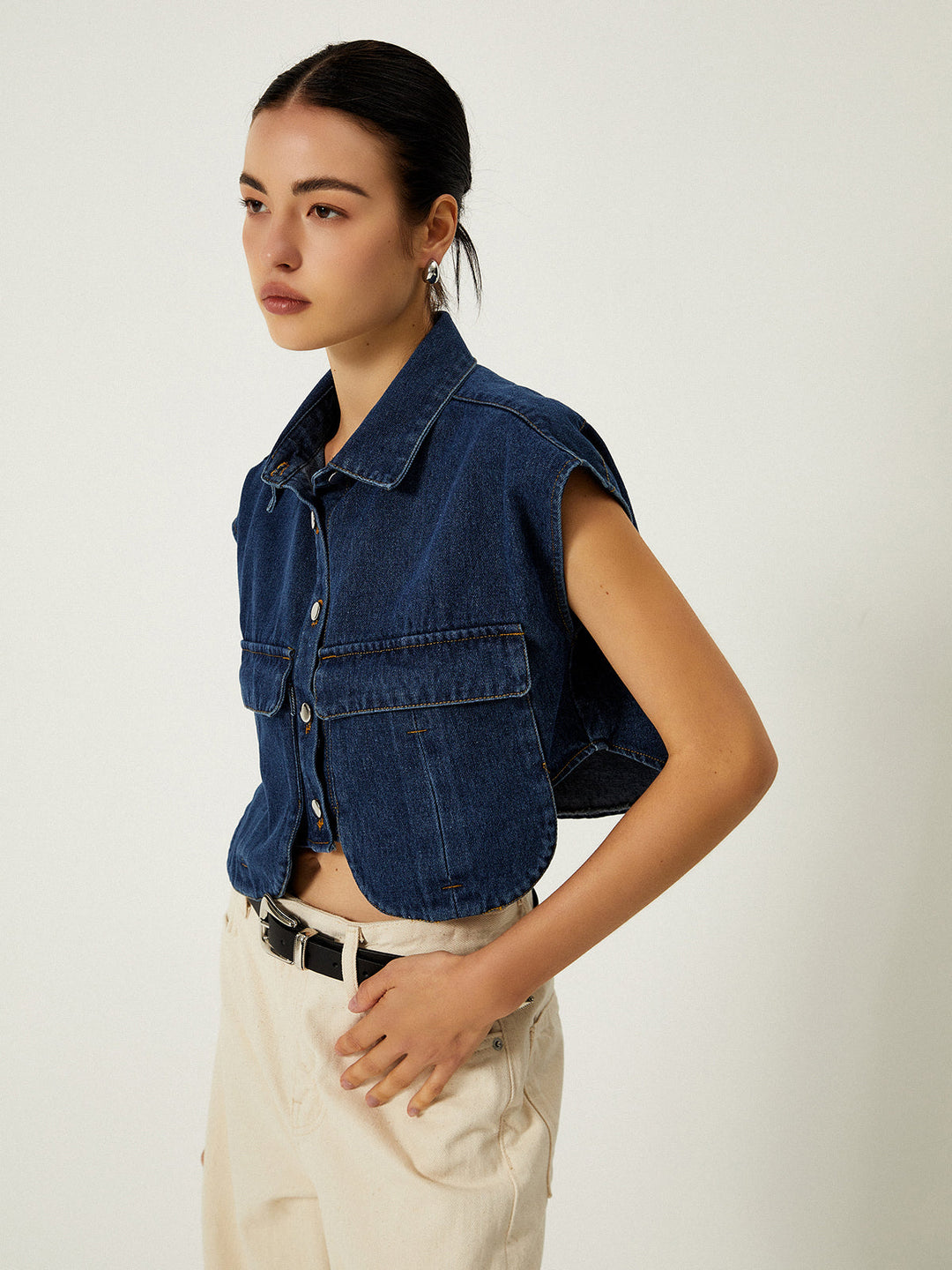 Three-quarter turn in sleeveless denim vest with extended cap shoulder seams