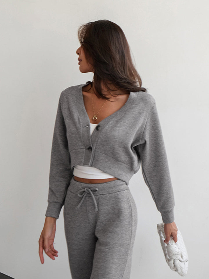 Back view of grey cropped sweatshirt jacket with scoop back and ribbed cuffs