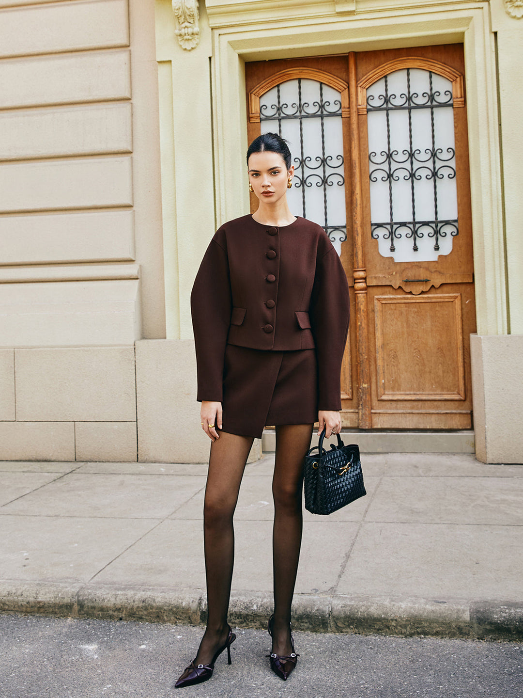 Retro brown two-piece with structured puff sleeve jacket and black sheer tights