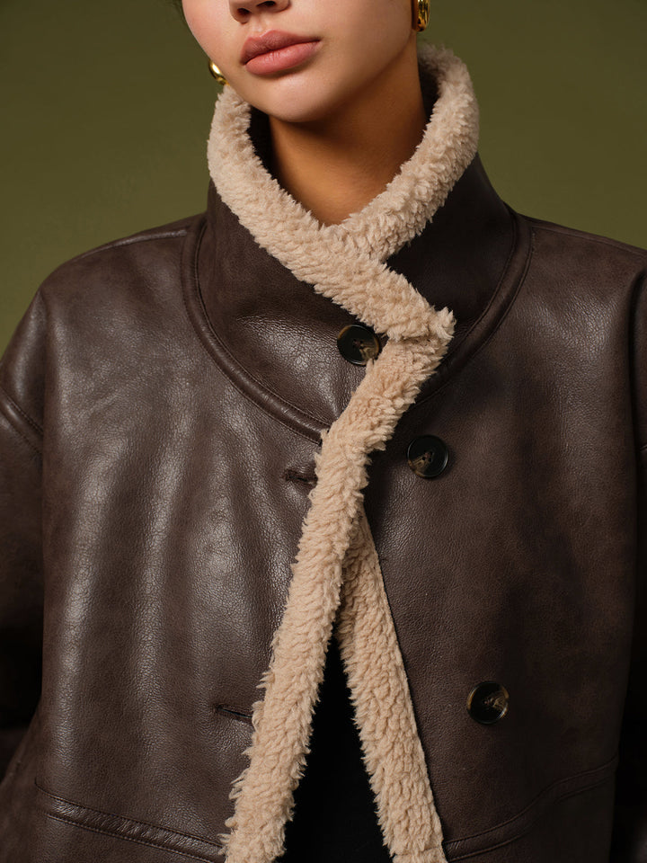Close-up of the fleece lined lapel and dark buttons on the brown PU leather winter jacket