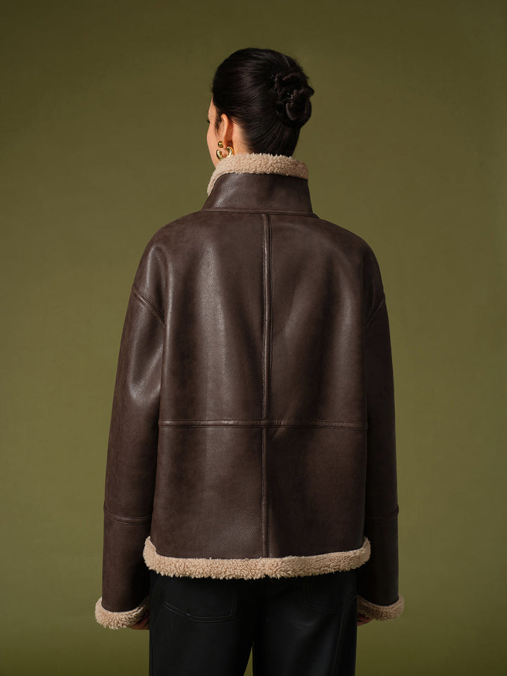 Back view of the oversized dark brown fleece lined leather jacket with cream hem trim