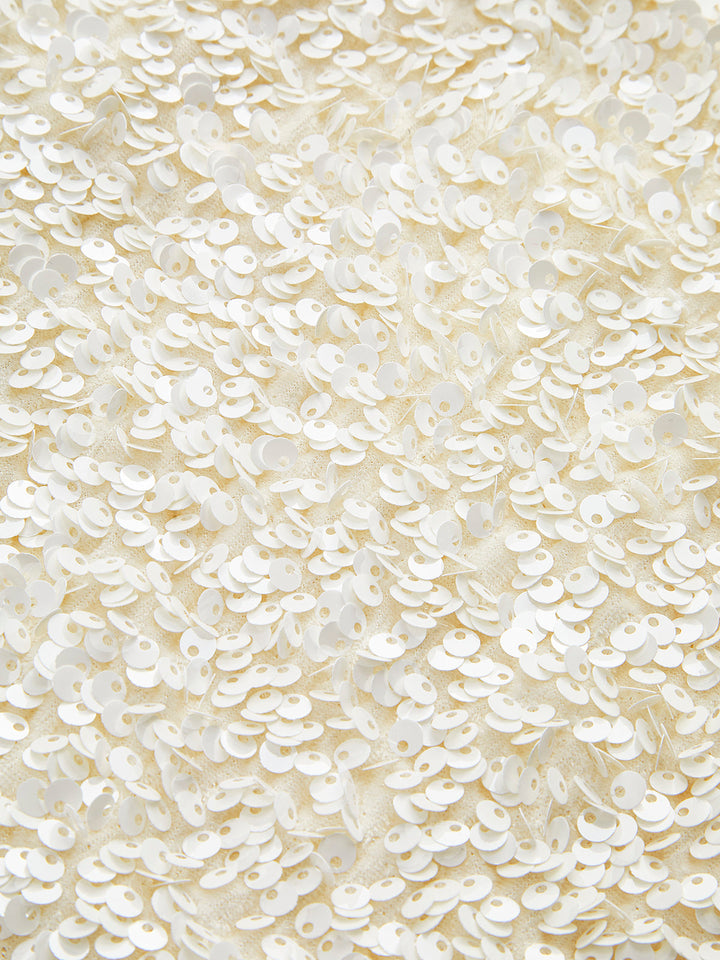Macro of the pearlescent ivory sequins covering the jacket