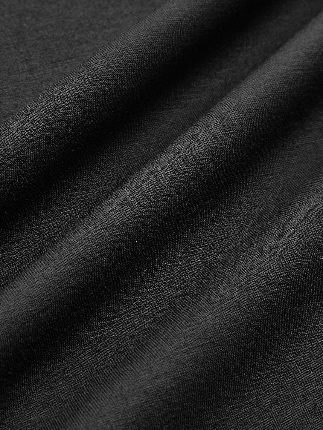 Macro of the smooth black knit fabric used for this puff sleeve cropped jacket