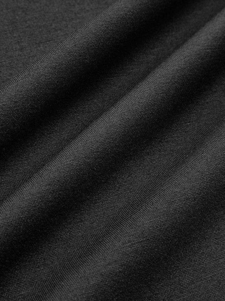 Macro of the smooth black knit fabric used for this puff sleeve cropped jacket