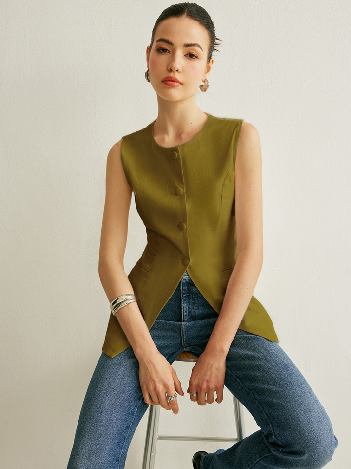 Olive army green version of the sleeveless button vest styled over straight-leg denim