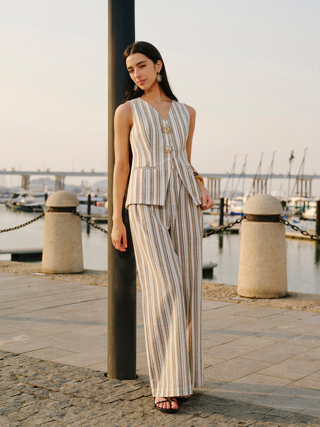 Full-length striped linen cotton vest set with black heeled sandals at sunset