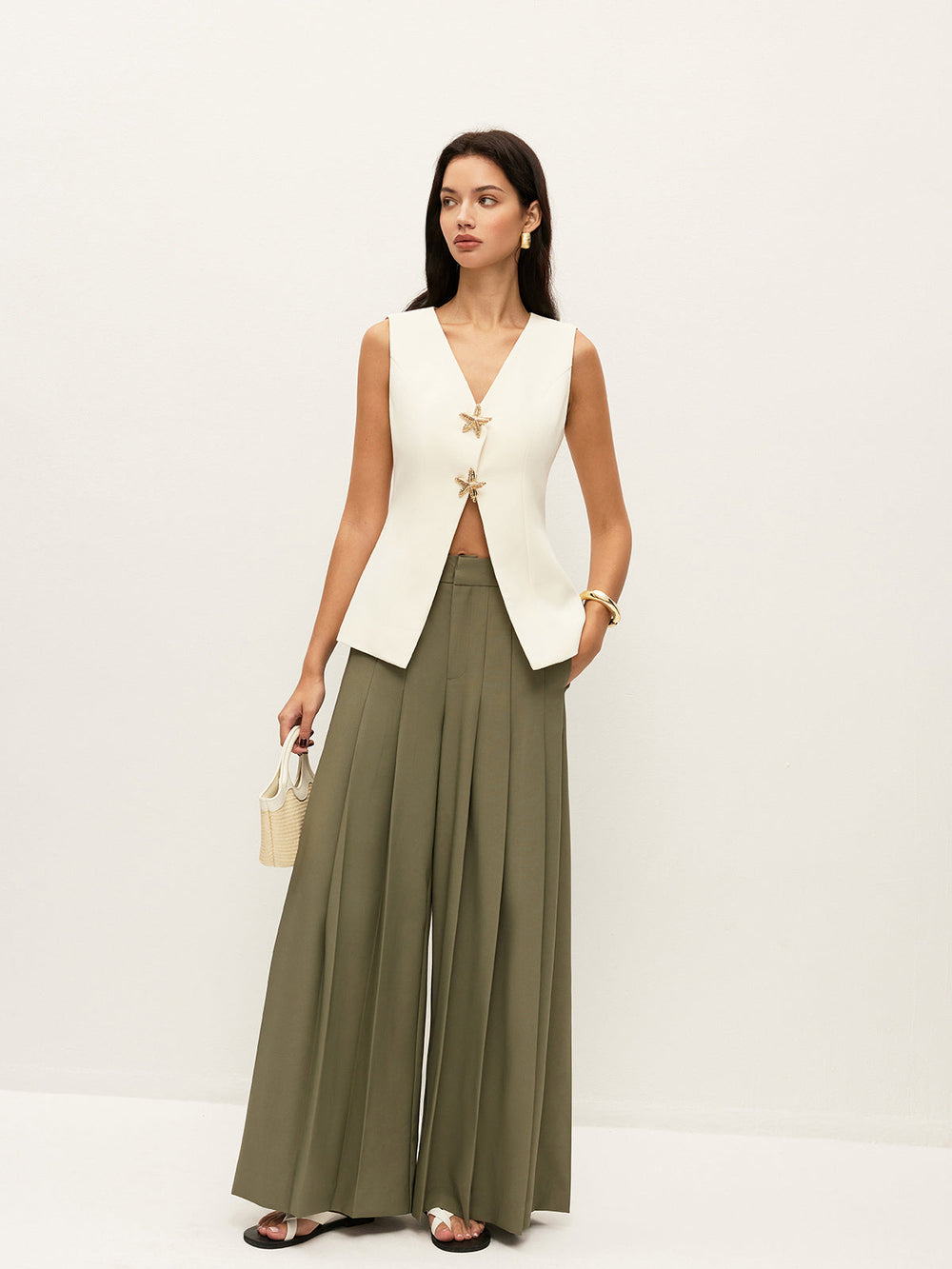 Full-length look: cream starfish-detail vest with olive green pleated palazzo pants and sandals