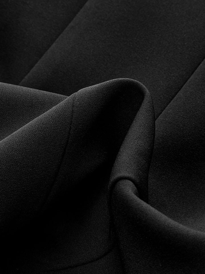 Macro of the draped black crepe fabric used for this belted wide shoulder vest