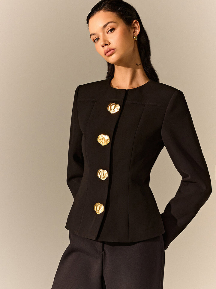 Three-quarter view of a nipped-waist black blazer with gold metal buttons and princess seams