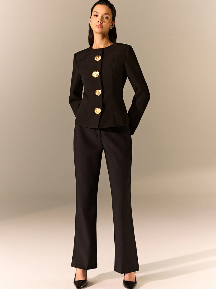 Full-length black suit look with a fitted gold button blazer and straight leg trousers