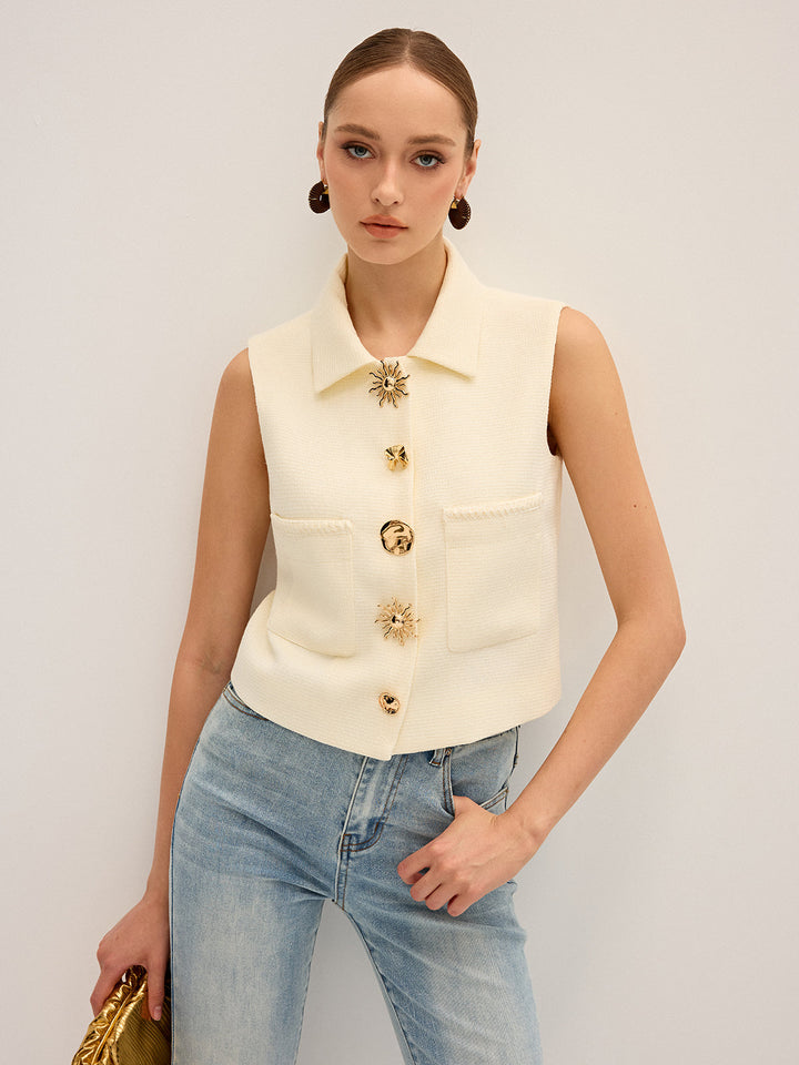 Cream collared sleeveless vest with irregular gold buttons and patch pockets, worn with jeans