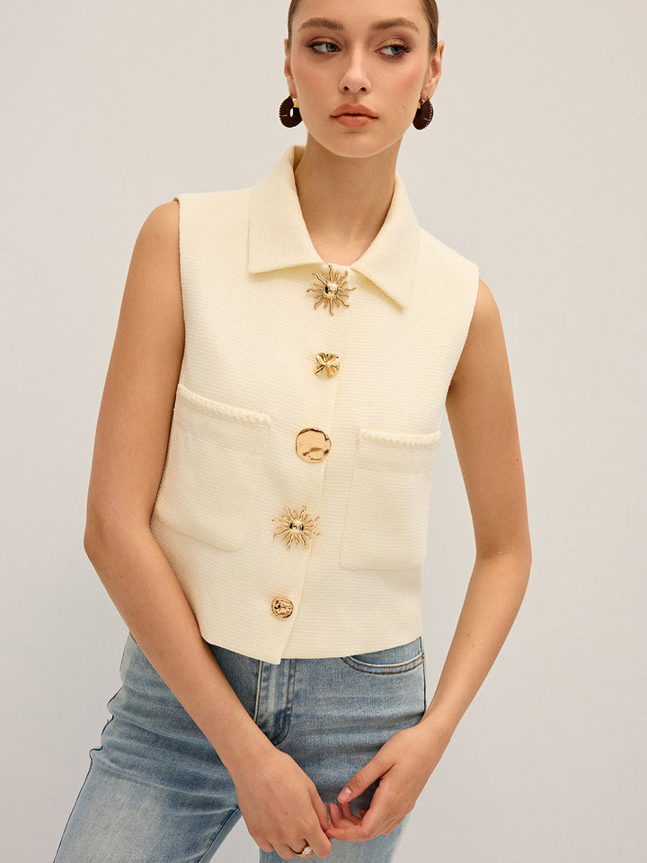 Angled view of the cream collared vest showing the boxy cropped fit over denim
