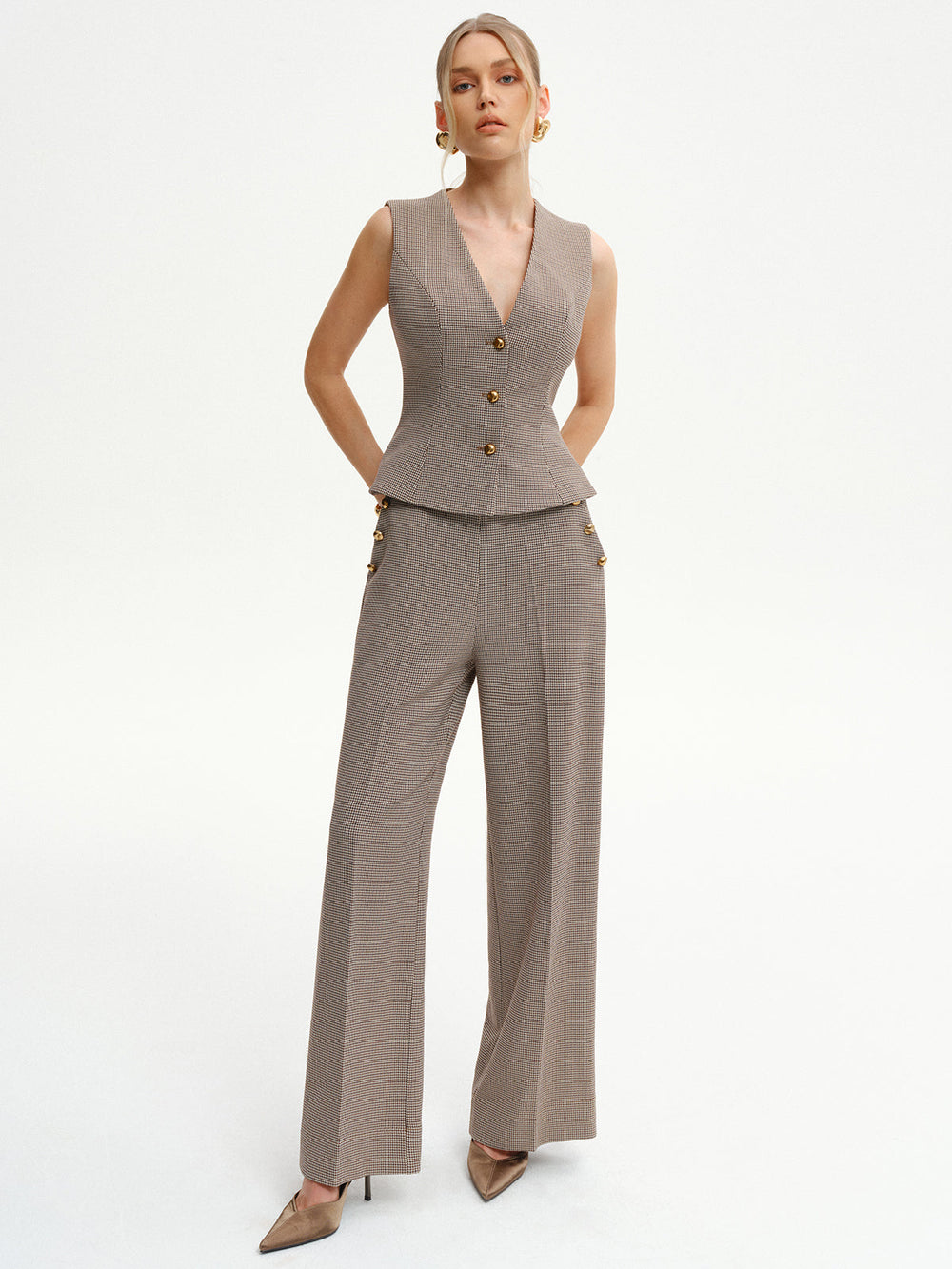 Full-length view of the houndstooth peplum waistcoat suit worn with pointed beige heels