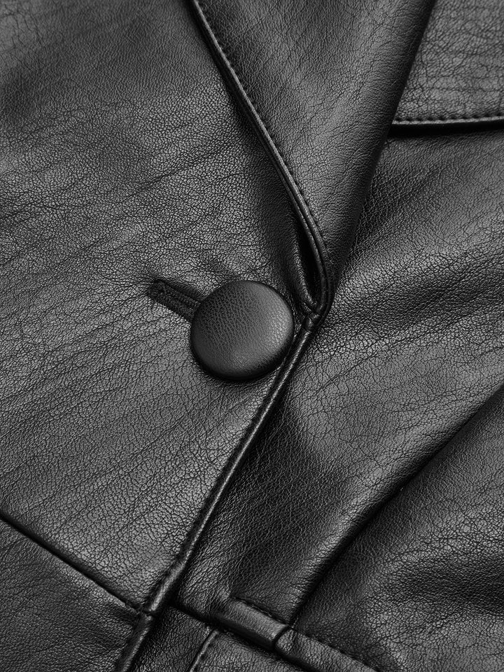 Close-up of the covered single button and piped lapel on the black leather blazer