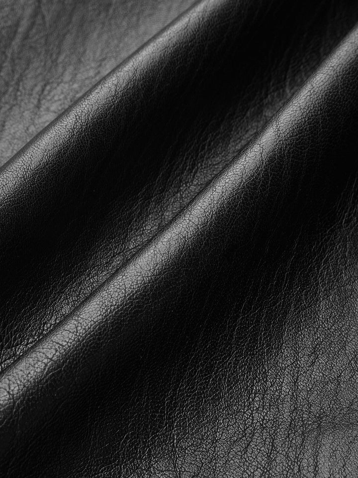 Macro of the smooth black vegan leather surface with subtle sheen
