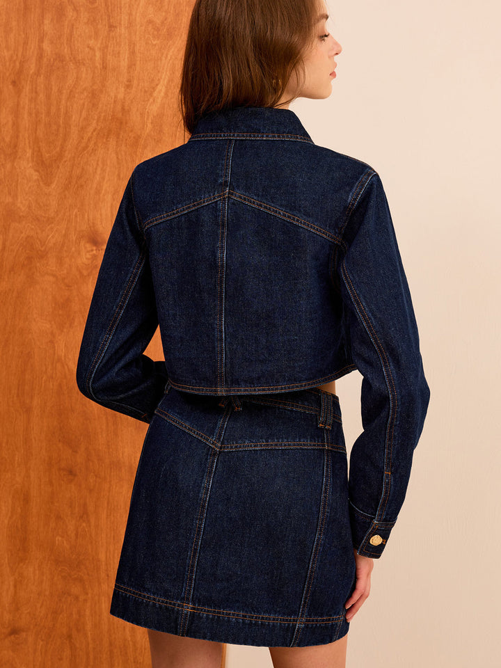 Back view of the cropped navy denim jacket with yoke seam and boxy fit