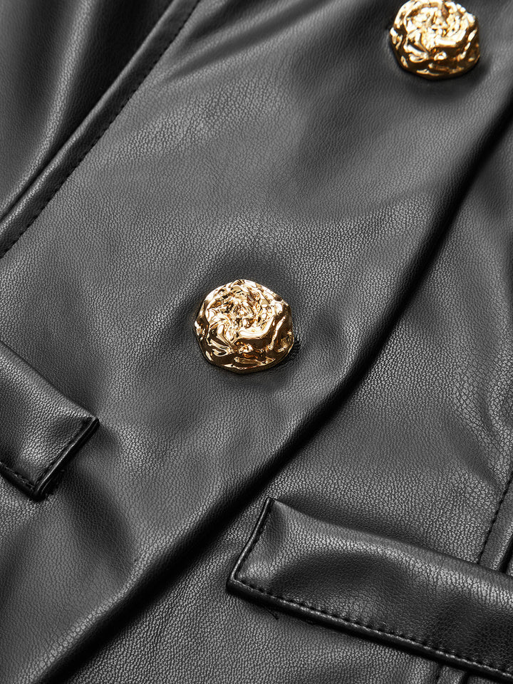 Close-up of ornate gold metal buttons on the placket of a black leather look jacket