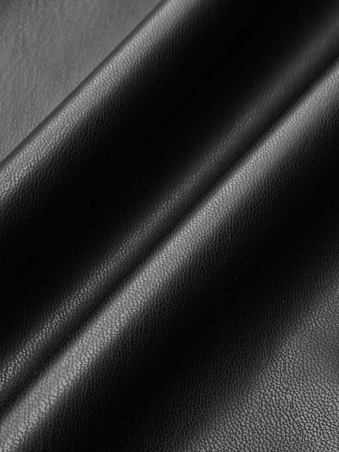 Macro of the soft matte black vegan leather used for this puff sleeve jacket