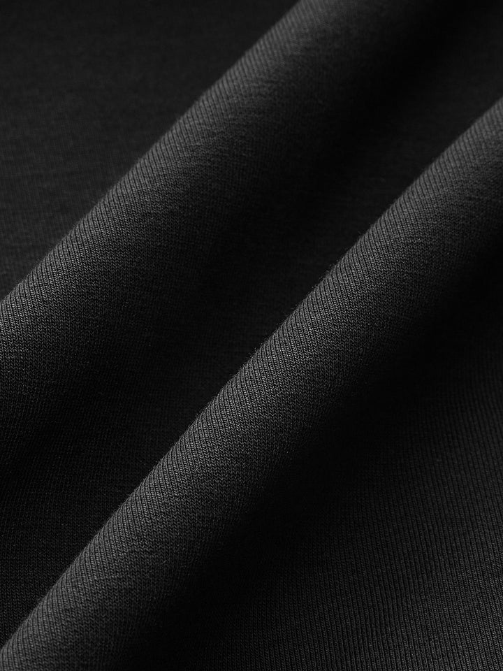 Macro of the matte black crepe fabric of the denim trim blouse