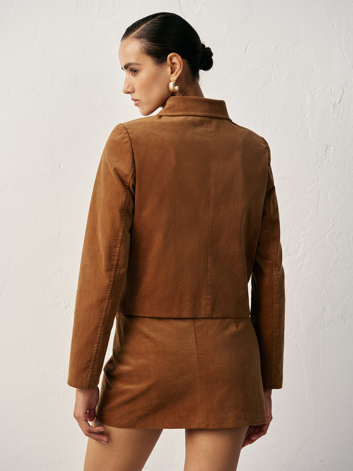 Back view of camel corduroy collared jacket showing cropped length and shoulder yoke