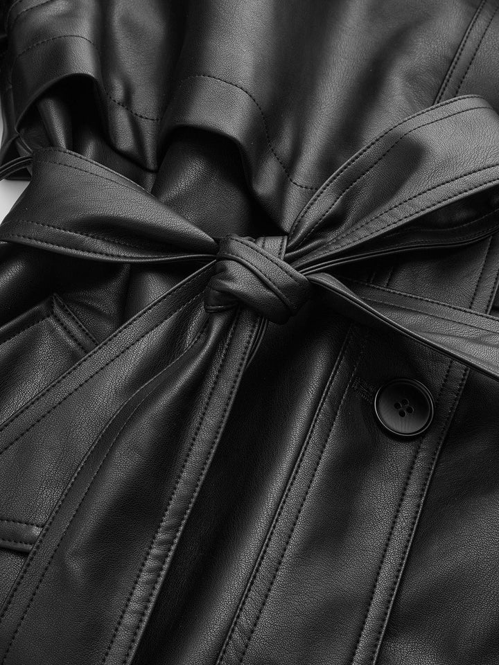Detail of the knotted self-tie waist belt on a black vegan leather jacket