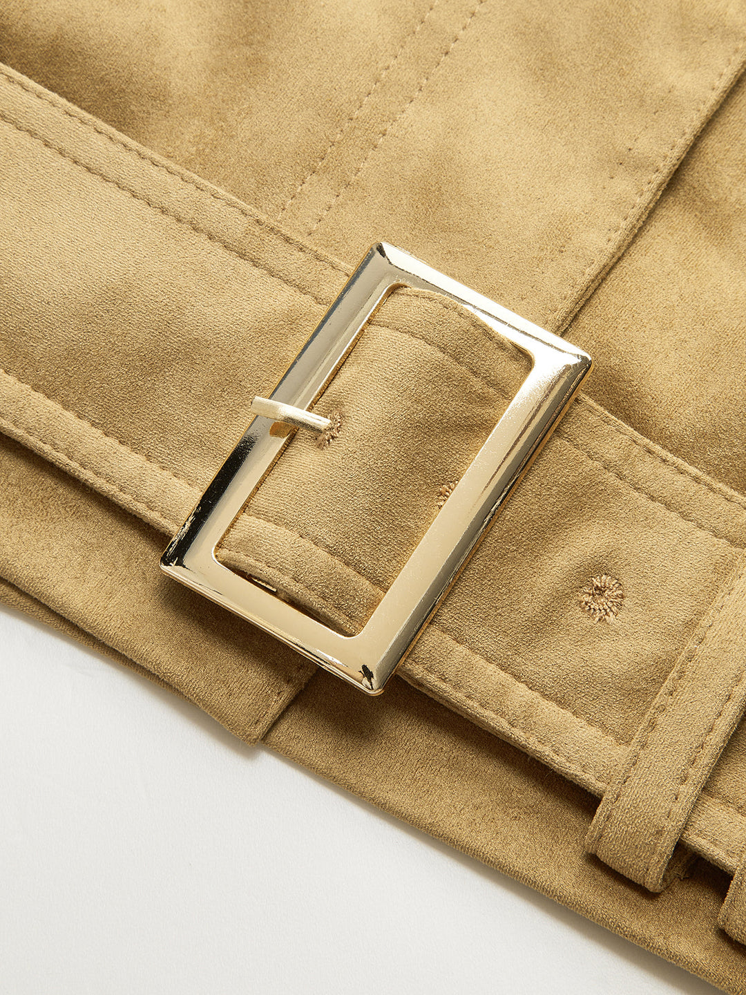 Macro of the silver square buckle on the khaki suede jacket belt