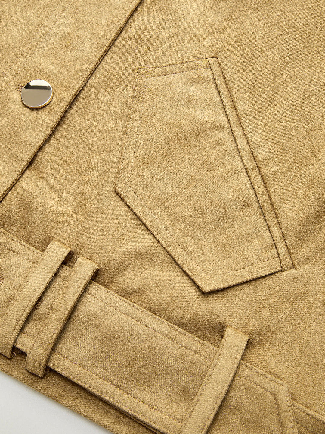 Detail of the angled flap pocket and belt loop on the tan suede jacket