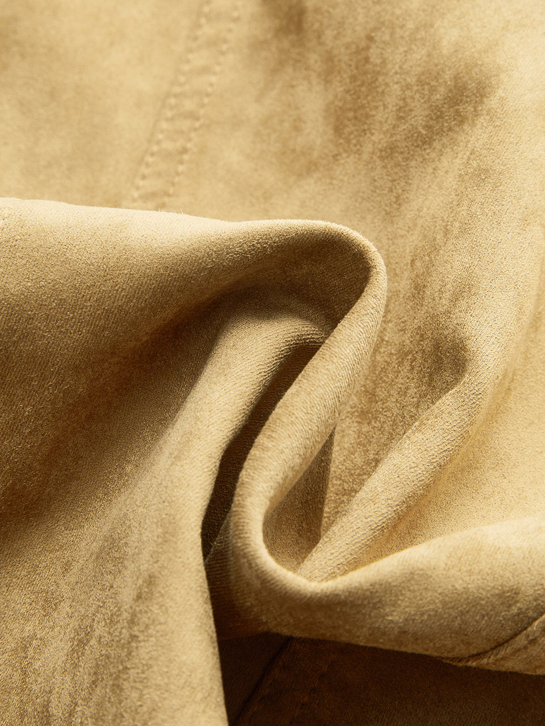 Macro of the soft khaki brushed suede fabric in gentle folds