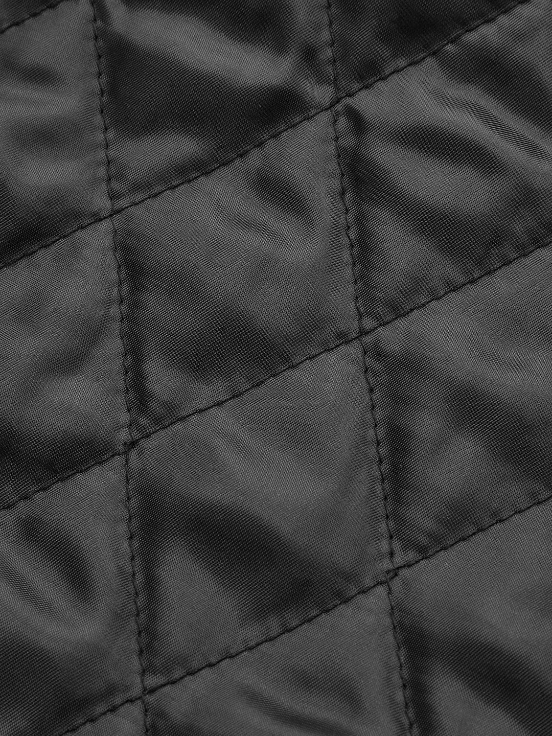 Macro of the diamond quilted stitching on black PU leather jacket panelling