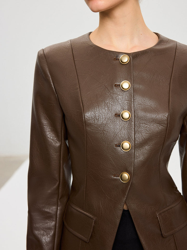 Close-up of antique gold buttons and collarless round neckline on a brown leather jacket