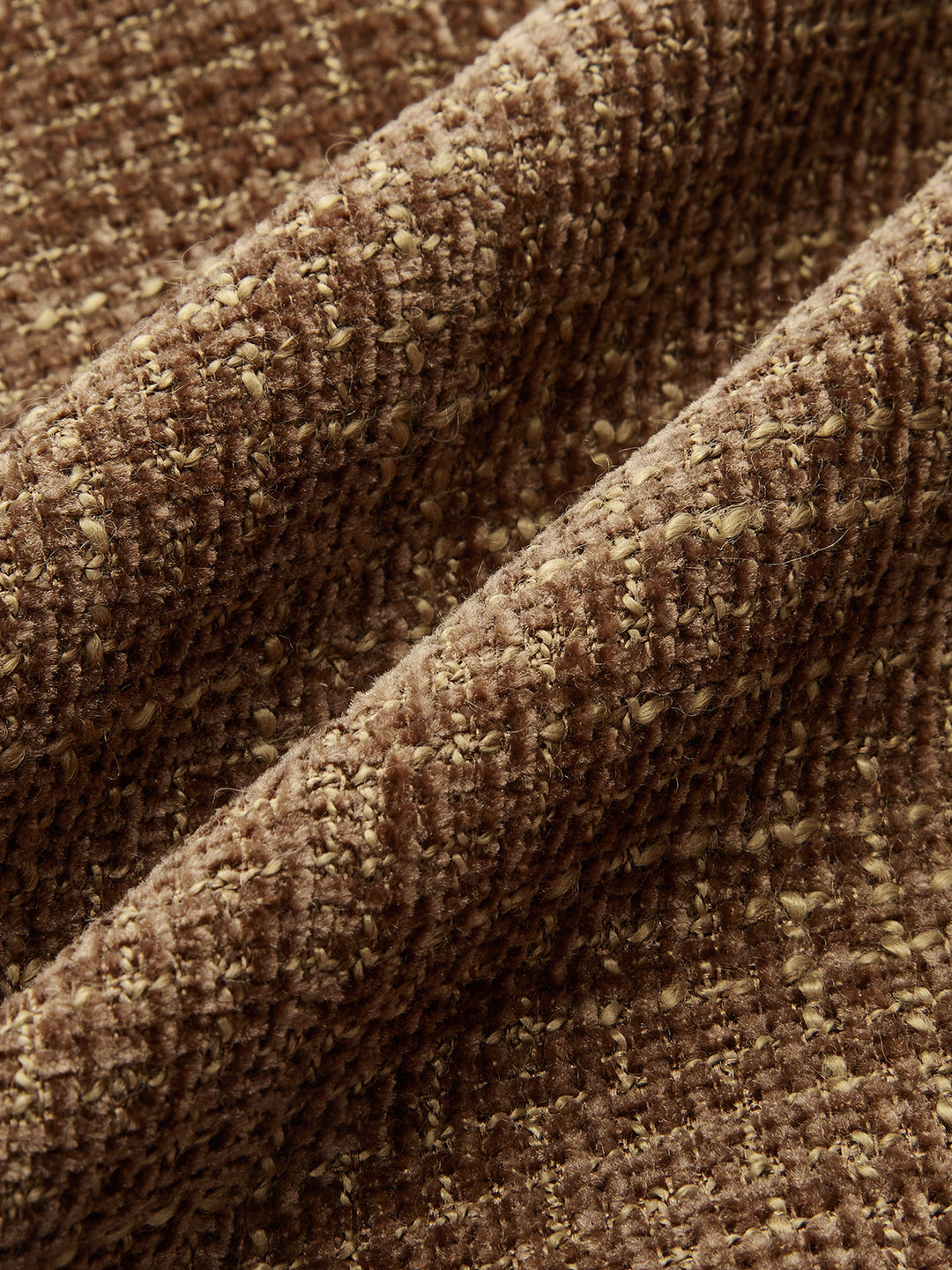 Macro of the brown and caramel boucle tweed weave used for this lapel jacket