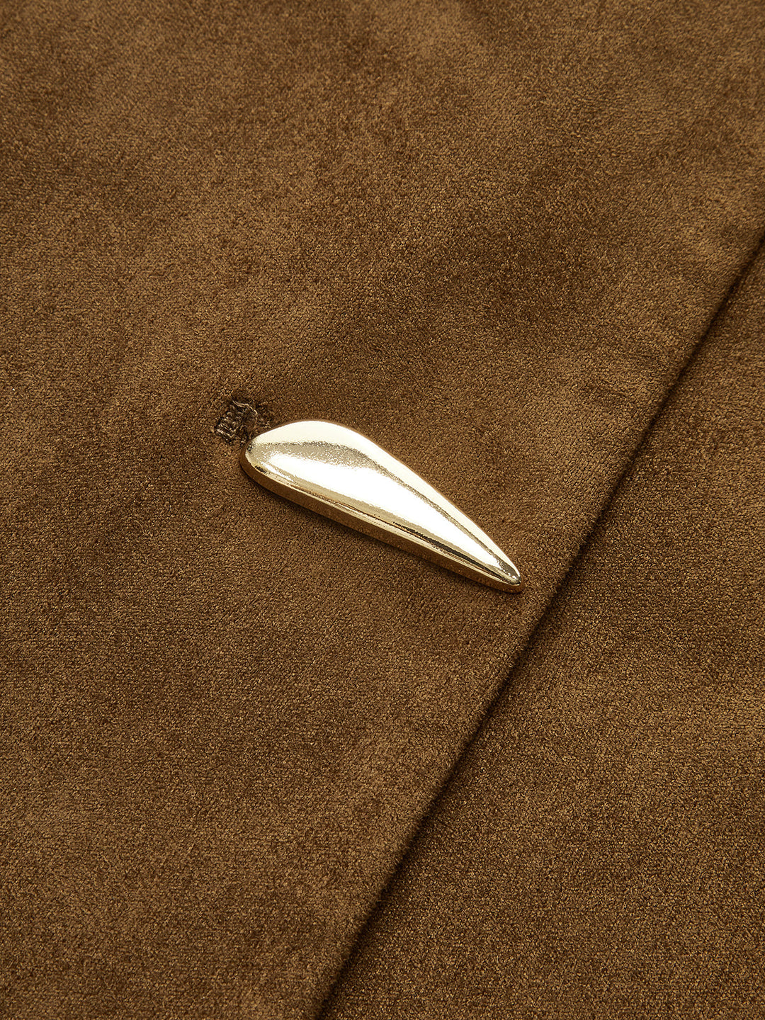 Close-up of a polished silver teardrop button on the brown suede vest placket