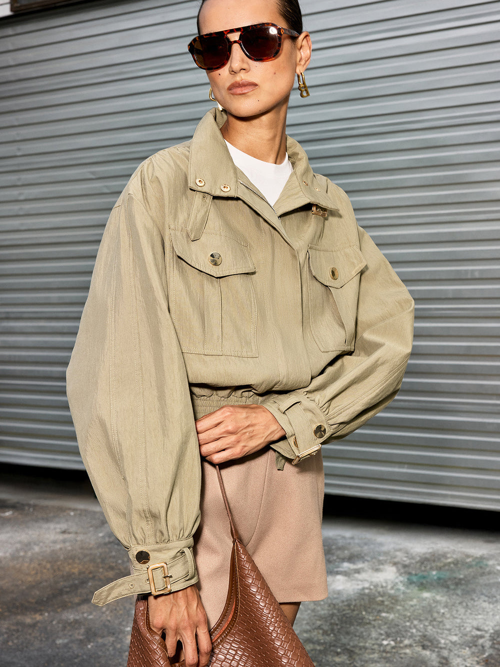 Front view of women's olive utility cropped jacket with flap chest pockets and balloon sleeves