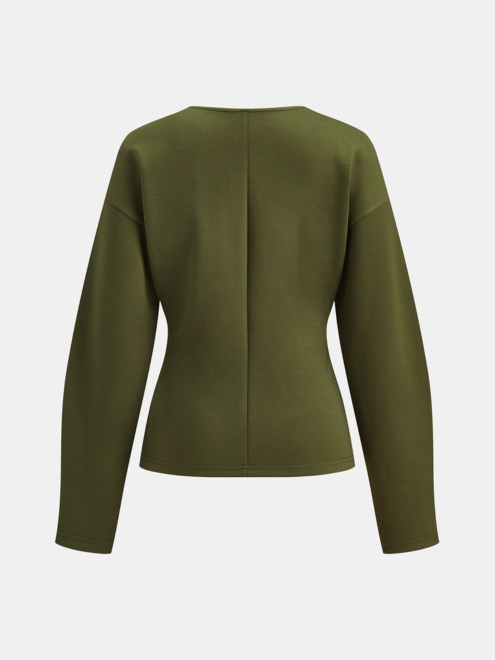 Back view of dark green longline knit cardigan showing nipped waist seam and drop shoulders