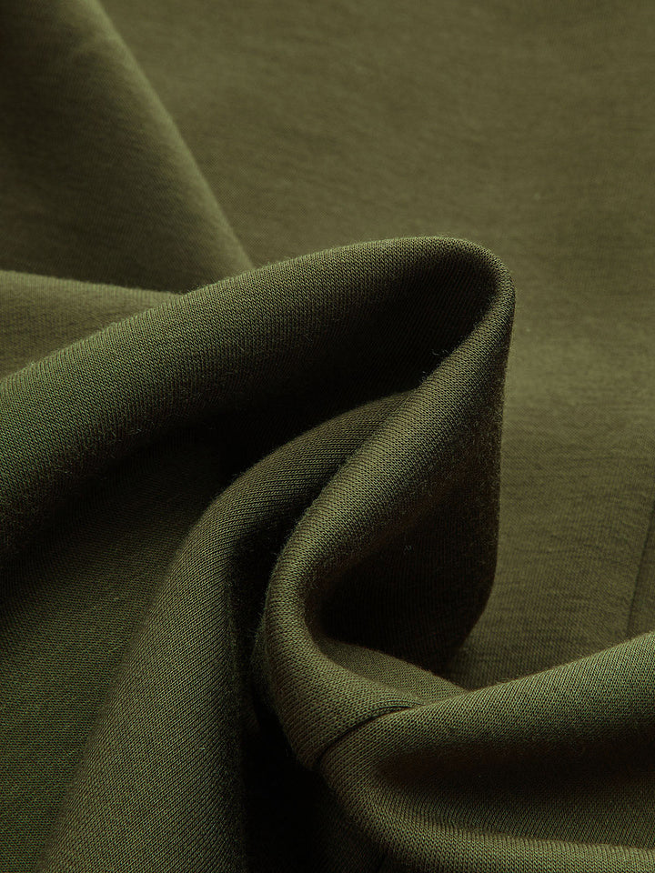 Macro shot of soft dark green knit fabric of the longline V-neck cardigan