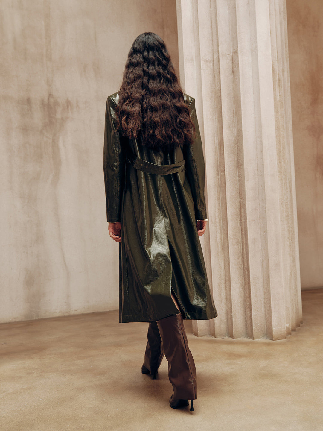 Back view of the belted army green leather coat with centre back vent and waist strap