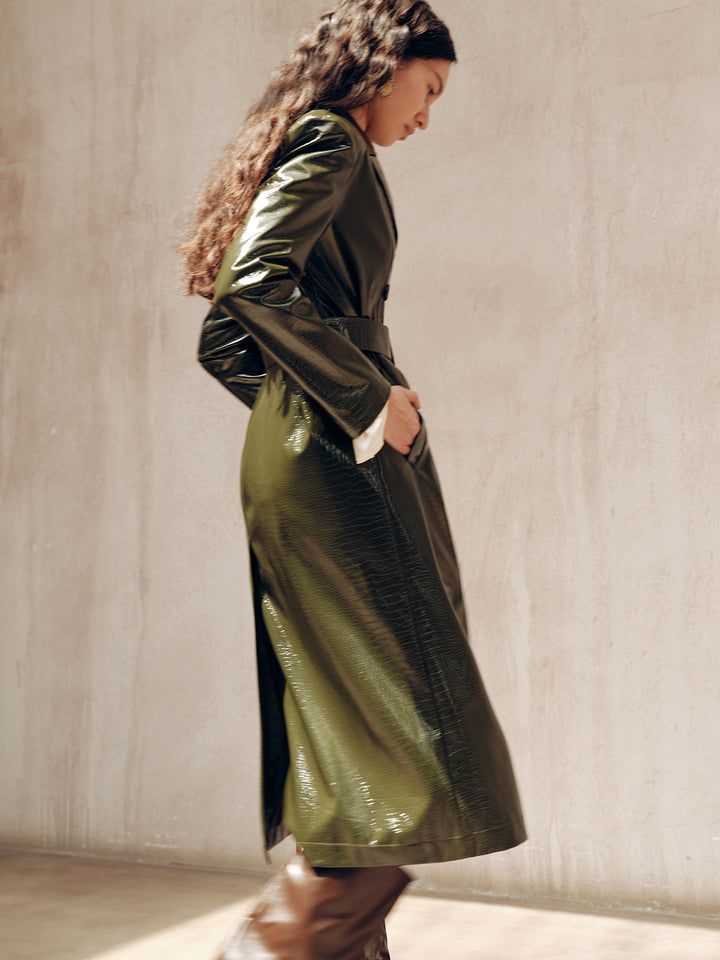 Profile shot of the gradient green PU trench coat catching the light on the sleeve